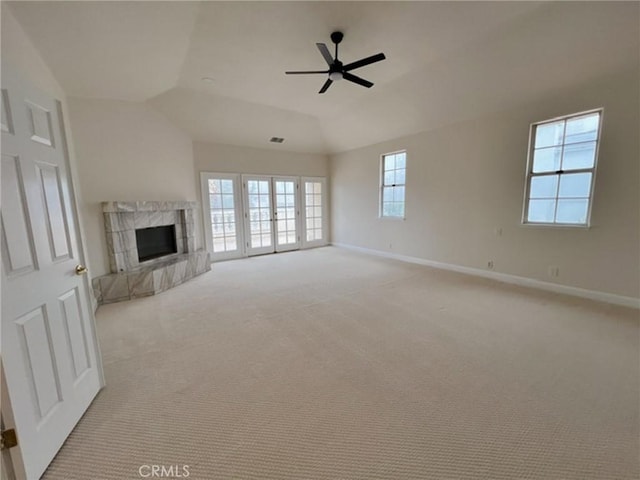 6926 Orozco Dr, Riverside, CA 92506 - unfurnished living room with a fireplace with raised hearth, a ceiling fan, lofted ceiling, and light carpet