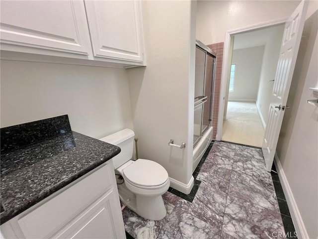 6926 Orozco Dr, Riverside, CA 92506 - bathroom with a shower with shower door, baseboards, vanity, toilet, and marble finish floor