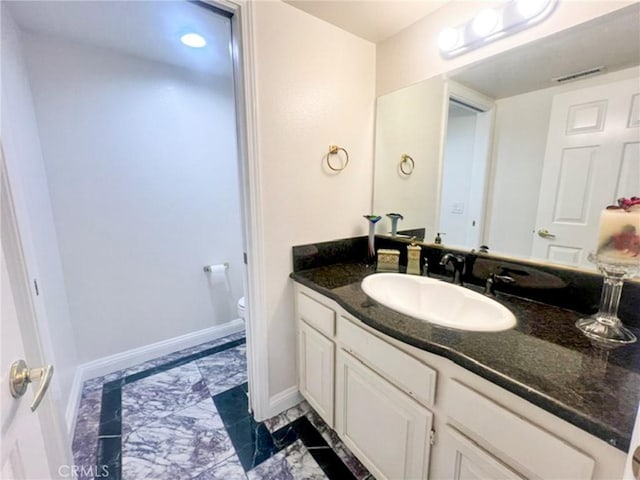 6926 Orozco Dr, Riverside, CA 92506 - bathroom with visible vents, baseboards, vanity, toilet, and marble finish floor
