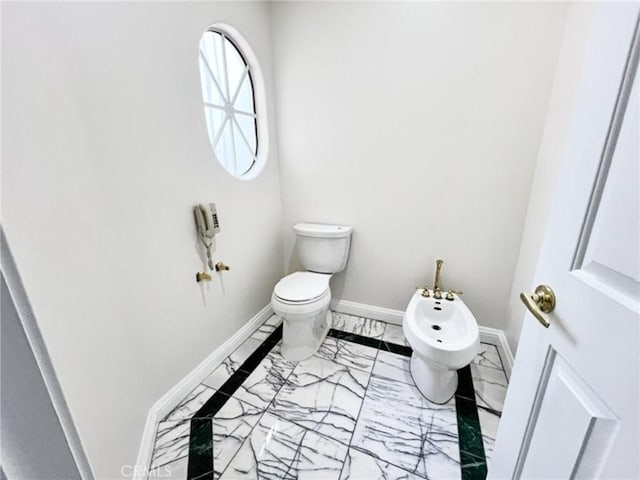 6926 Orozco Dr, Riverside, CA 92506 - half bath with baseboards, toilet, a bidet, and marble finish floor