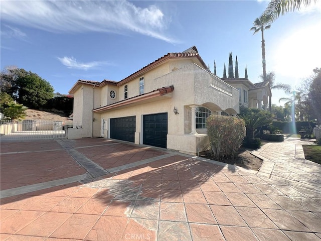 6926 Orozco Dr, Riverside, CA 92506 - view of property exterior featuring fence, stucco siding, driveway, and a tiled roof