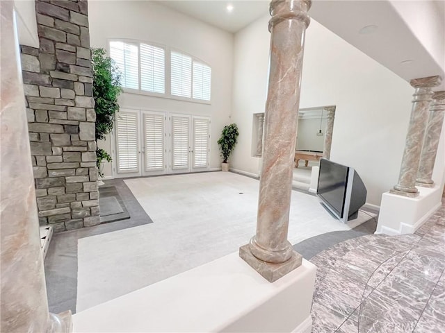 6926 Orozco Dr, Riverside, CA 92506 - entryway with ornate columns, baseboards, carpet, and a towering ceiling