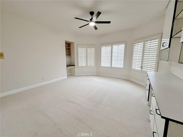 6926 Orozco Dr, Riverside, CA 92506 - unfurnished living room featuring baseboards, ceiling fan, and light carpet