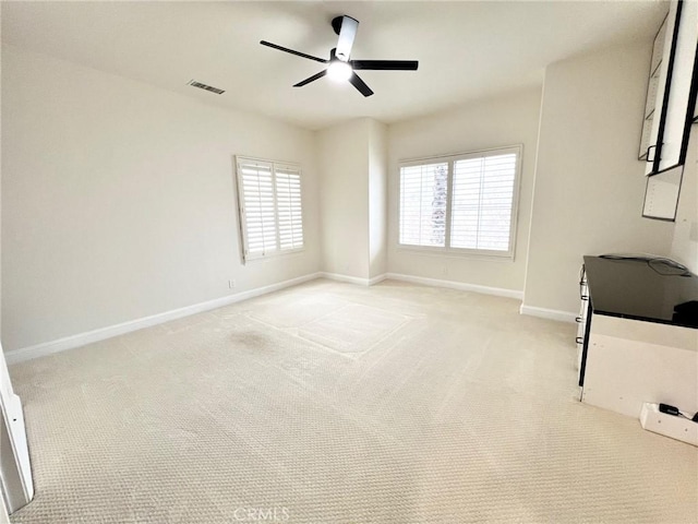 6926 Orozco Dr, Riverside, CA 92506 - empty room with visible vents, baseboards, ceiling fan, and light colored carpet