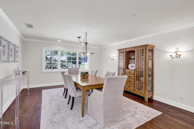 dining space featuring baseboards, ornamental molding, wood finished floors, and visible vents