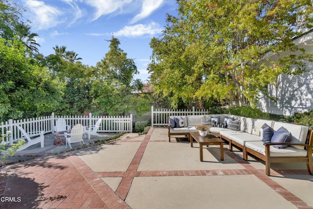 view of patio with an outdoor living space and fence