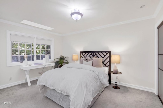 bedroom featuring crown molding, a skylight, and carpet floors