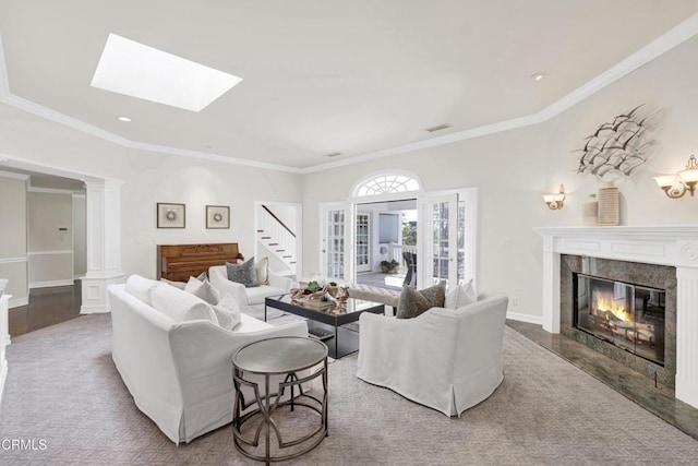 living area featuring visible vents, ornamental molding, stairs, and a fireplace