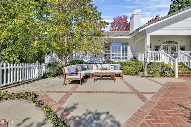 view of patio with fence and outdoor lounge area