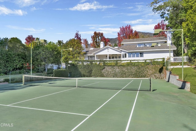 view of tennis court with fence