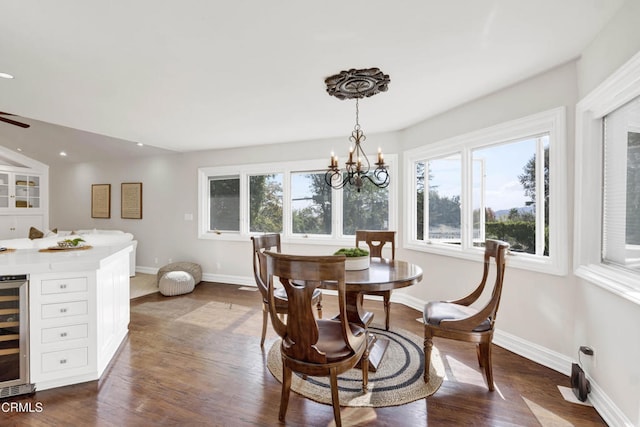 dining area with beverage cooler, recessed lighting, a wealth of natural light, and an inviting chandelier