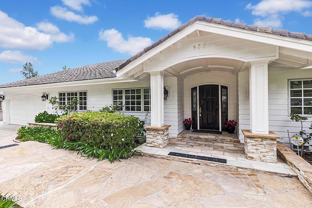 doorway to property with an attached garage