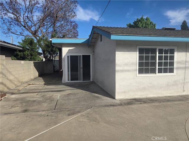 13511 Epping Way, Tustin, CA 92780 - doorway to property featuring stucco siding, a patio, and fence