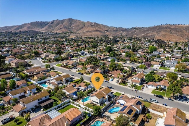 birds eye view of property with a mountain view and a residential view