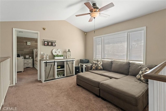 carpeted living area with a ceiling fan and lofted ceiling