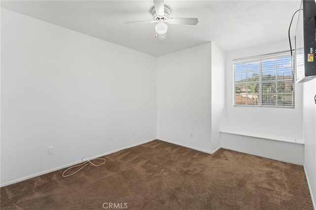 unfurnished room with baseboards, carpet flooring, and ceiling fan