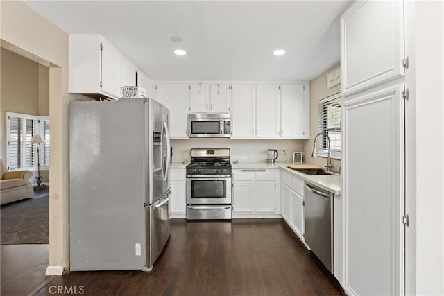 kitchen featuring dark wood-style flooring, appliances with stainless steel finishes, and a sink