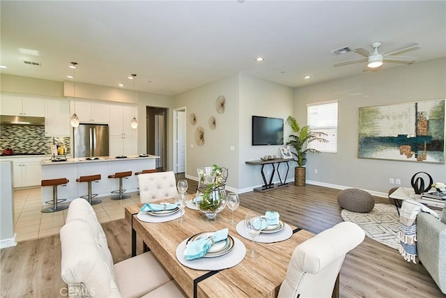 dining area with light wood-style floors, ceiling fan, recessed lighting, and visible vents