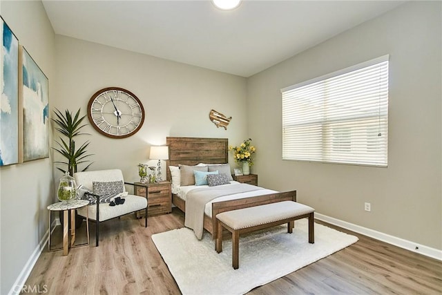 bedroom featuring baseboards and wood finished floors