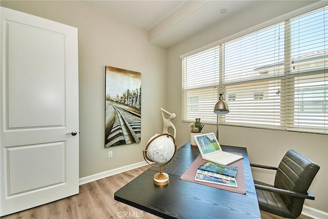 office space with baseboards and wood finished floors