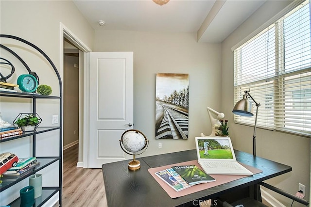 office with light wood-style floors and baseboards