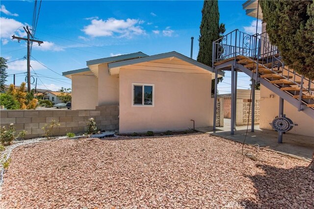 3882 Dwiggins St, Los Angeles, CA 90063 - view of home's exterior with stucco siding, stairs, and a patio