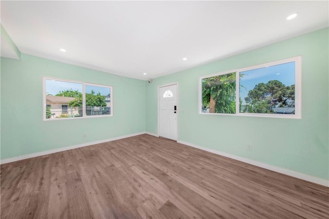 3882 Dwiggins St, Los Angeles, CA 90063 - unfurnished living room featuring wood finished floors, baseboards, and recessed lighting