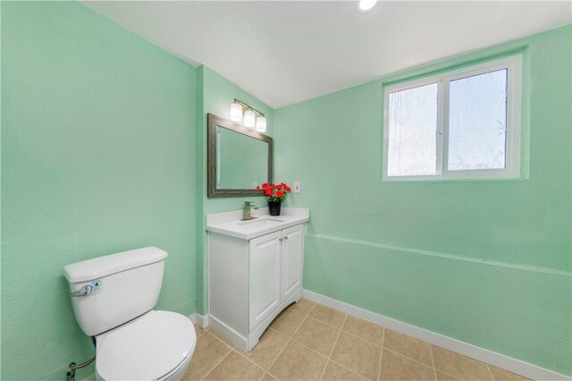 3882 Dwiggins St, Los Angeles, CA 90063 - half bath featuring vanity, toilet, baseboards, and tile patterned flooring