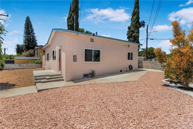 3882 Dwiggins St, Los Angeles, CA 90063 - back of property with stucco siding and a patio