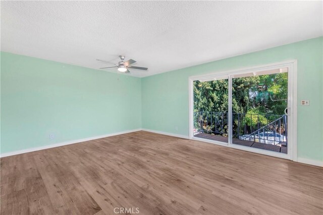 3882 Dwiggins St, Los Angeles, CA 90063 - empty room featuring wood finished floors, a textured ceiling, baseboards, and a ceiling fan