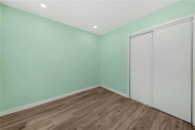 3882 Dwiggins St, Los Angeles, CA 90063 - unfurnished bedroom with wood finished floors, baseboards, a closet, and recessed lighting