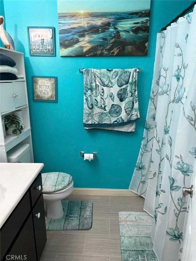 12426 2nd St, Yucaipa, CA 92399 - bathroom featuring vanity, baseboards, and toilet