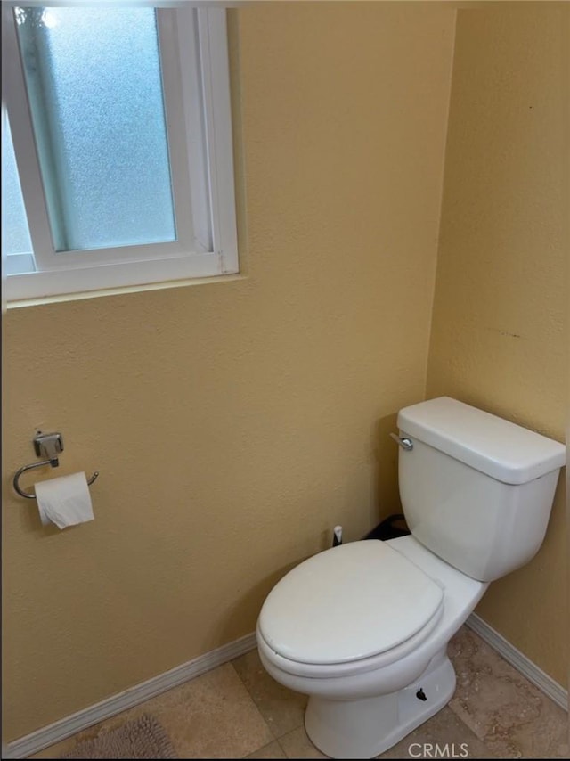 12426 2nd St, Yucaipa, CA 92399 - bathroom featuring toilet, baseboards, and tile patterned flooring