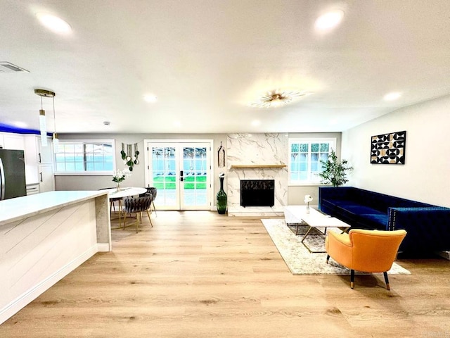 living area with visible vents, recessed lighting, light wood-style floors, and a wealth of natural light