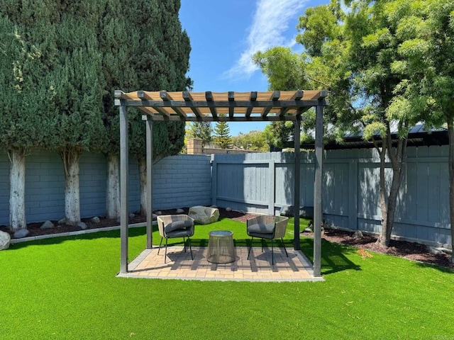 view of yard featuring a fenced backyard, a pergola, and a patio area