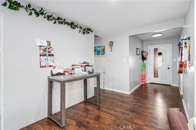 entryway featuring baseboards and wood finished floors