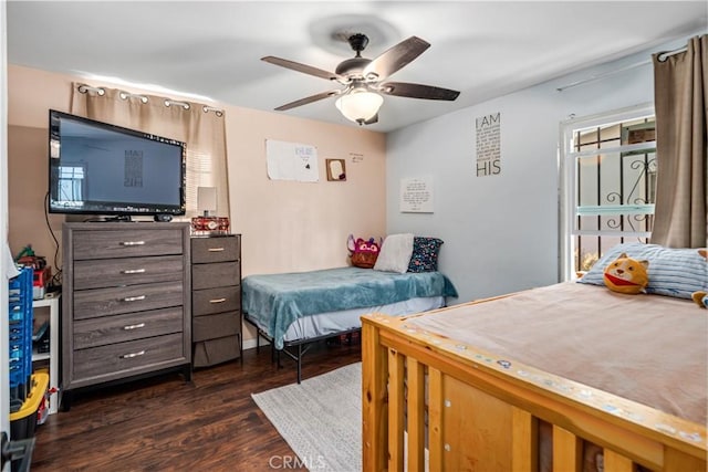 bedroom featuring a ceiling fan and dark wood-style floors