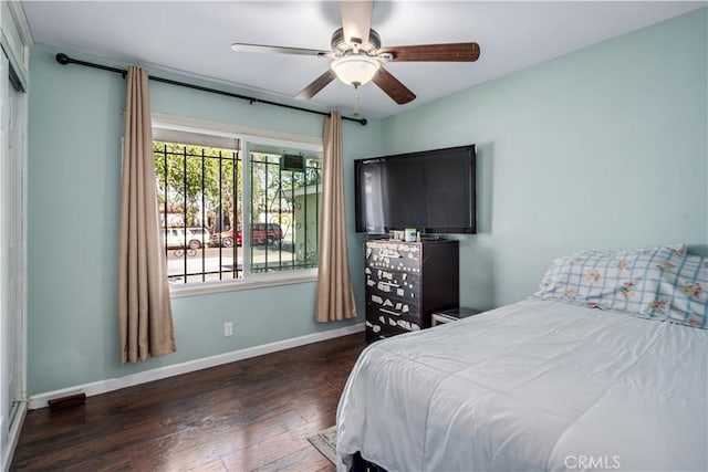 bedroom featuring baseboards, a ceiling fan, and wood finished floors