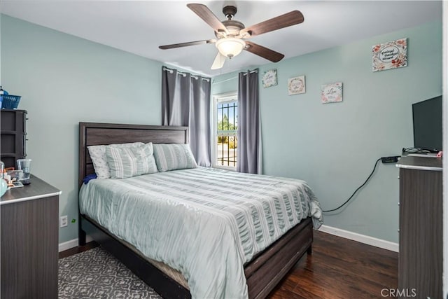 bedroom featuring baseboards, ceiling fan, and wood finished floors