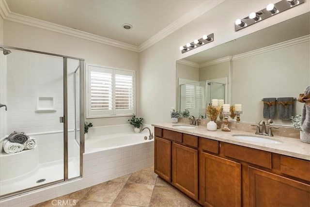 full bath with a sink, crown molding, a stall shower, and a garden tub