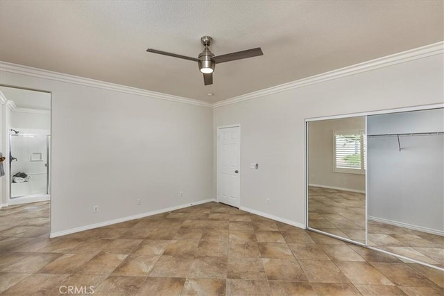 unfurnished bedroom with crown molding, a ceiling fan, baseboards, and two closets