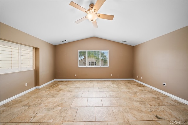 spare room with ceiling fan, vaulted ceiling, baseboards, and visible vents