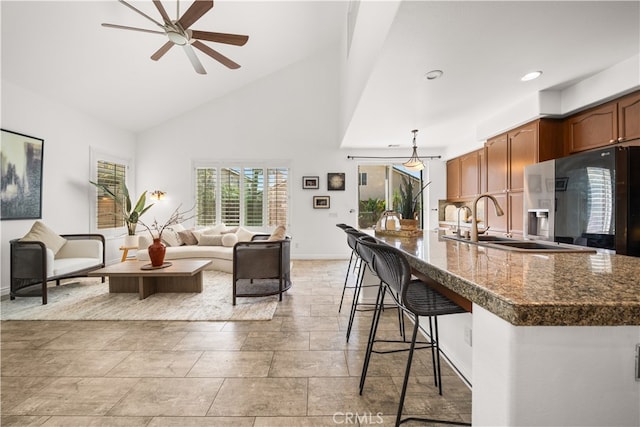 living area featuring recessed lighting, baseboards, ceiling fan, and high vaulted ceiling