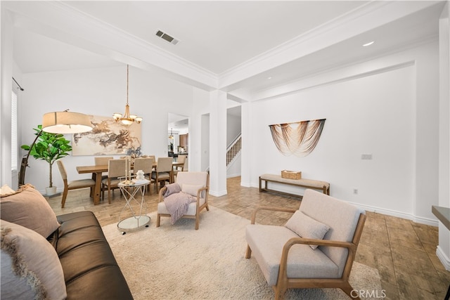 living area featuring a notable chandelier, baseboards, visible vents, ornamental molding, and stairway
