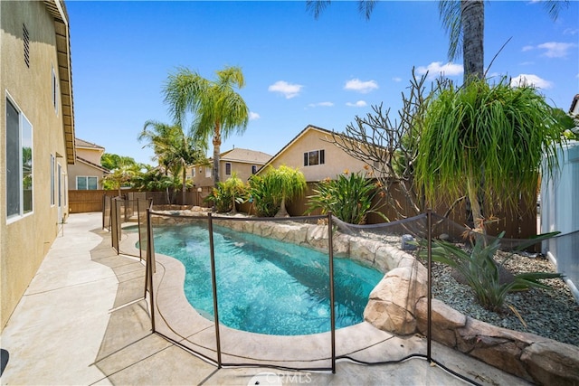 view of swimming pool with a patio, a fenced backyard, and a fenced in pool