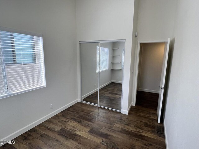 333 Highland Dr, Oxnard, CA 93035 - unfurnished bedroom with dark wood-type flooring, a closet, and a towering ceiling