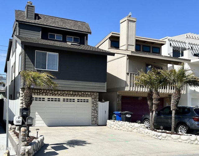 333 Highland Dr, Oxnard, CA 93035 - view of front of property with a chimney, concrete driveway, a garage, and stone siding