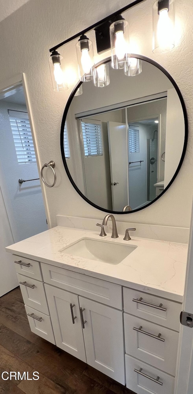 333 Highland Dr, Oxnard, CA 93035 - bathroom featuring vanity, wood finished floors, and a textured wall