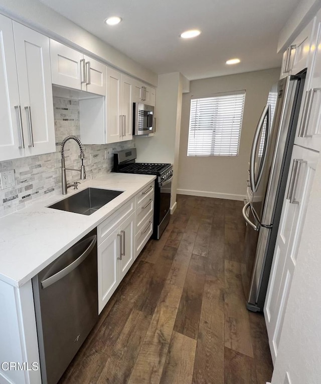 333 Highland Dr, Oxnard, CA 93035 - kitchen with appliances with stainless steel finishes, decorative backsplash, white cabinets, light countertops, and dark wood finished floors