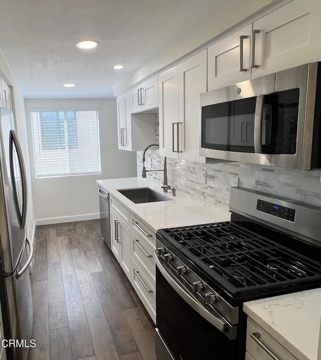 333 Highland Dr, Oxnard, CA 93035 - kitchen featuring stainless steel appliances, tasteful backsplash, white cabinetry, dark wood-style flooring, and recessed lighting